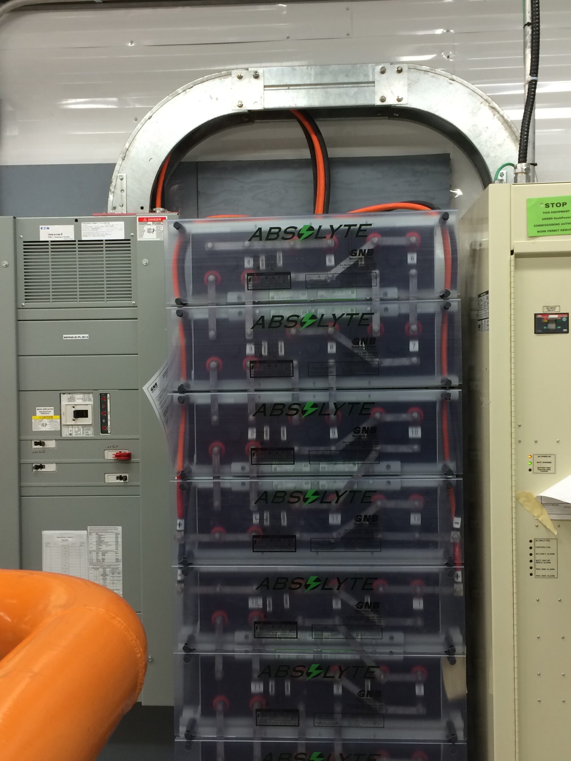 Carbon capture battery bank Electrician standing behind the electric box
